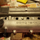 Prepping the valve cover, including plugging the holes for all of the bolts with wet tissues.